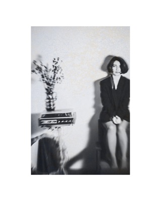 Lusine Baghdasaryan, photographed by Lilit L Hovhanni: seated at a tiled sink, in black and white.