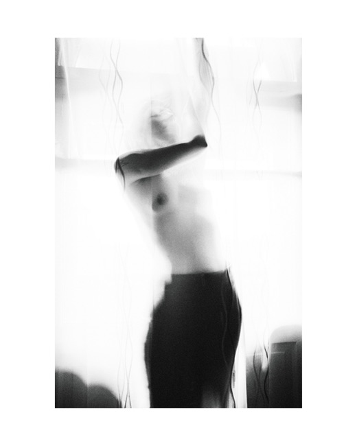Sirin, photographed by Lilit L Hovhanni: an abstract portrait study, the figure broken up by reflection.