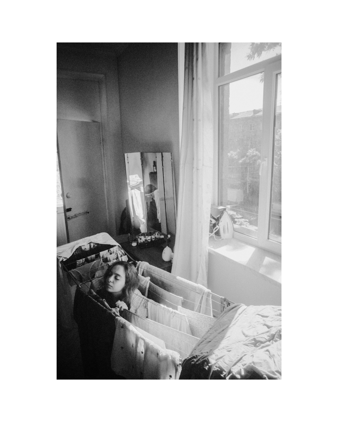 Monochrome view of a woman in a furnished room by Lilit L Hovhanni.