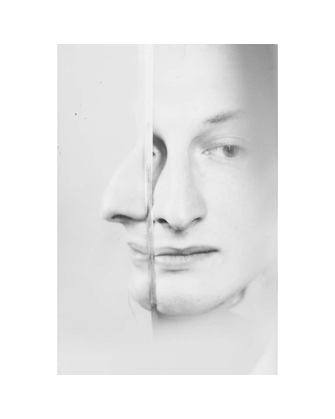 A tightly framed person in contrasting light and shadow, in black and white by Lilit L Hovhanni.
