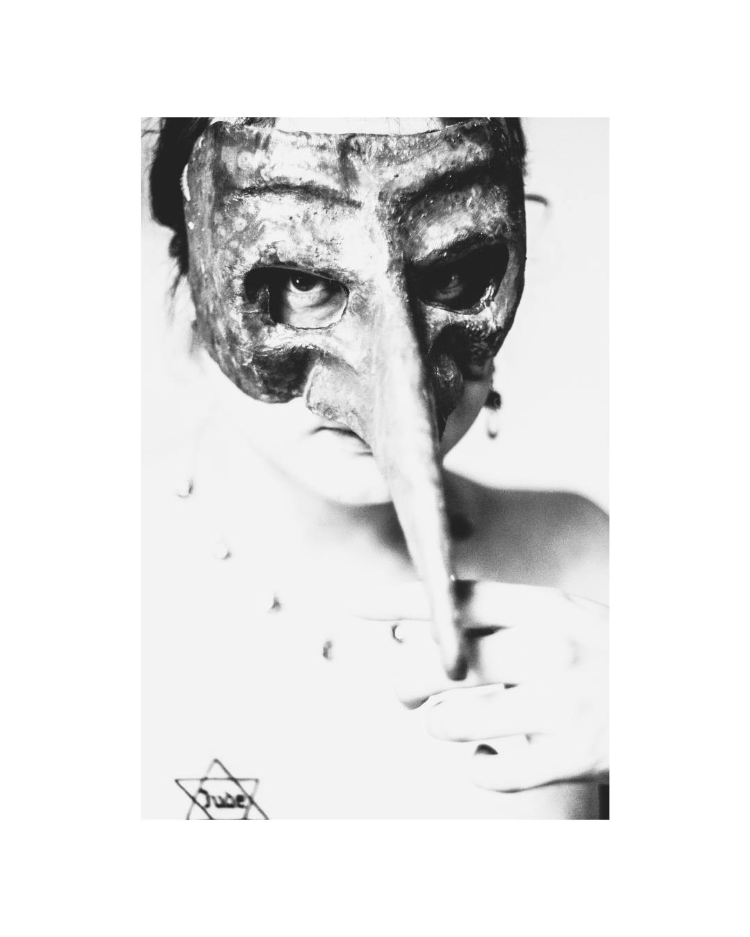 A person fills a vertical black-and-white frame, with bright highlights and deep shadows.