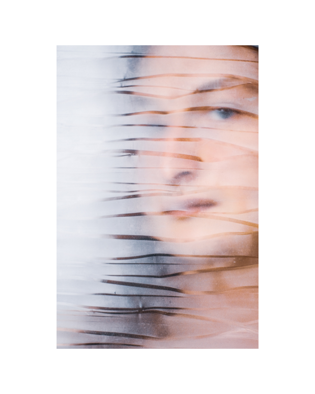 A close portrait of a long-haired person with bare skin visible, by Lilit L Hovhanni.