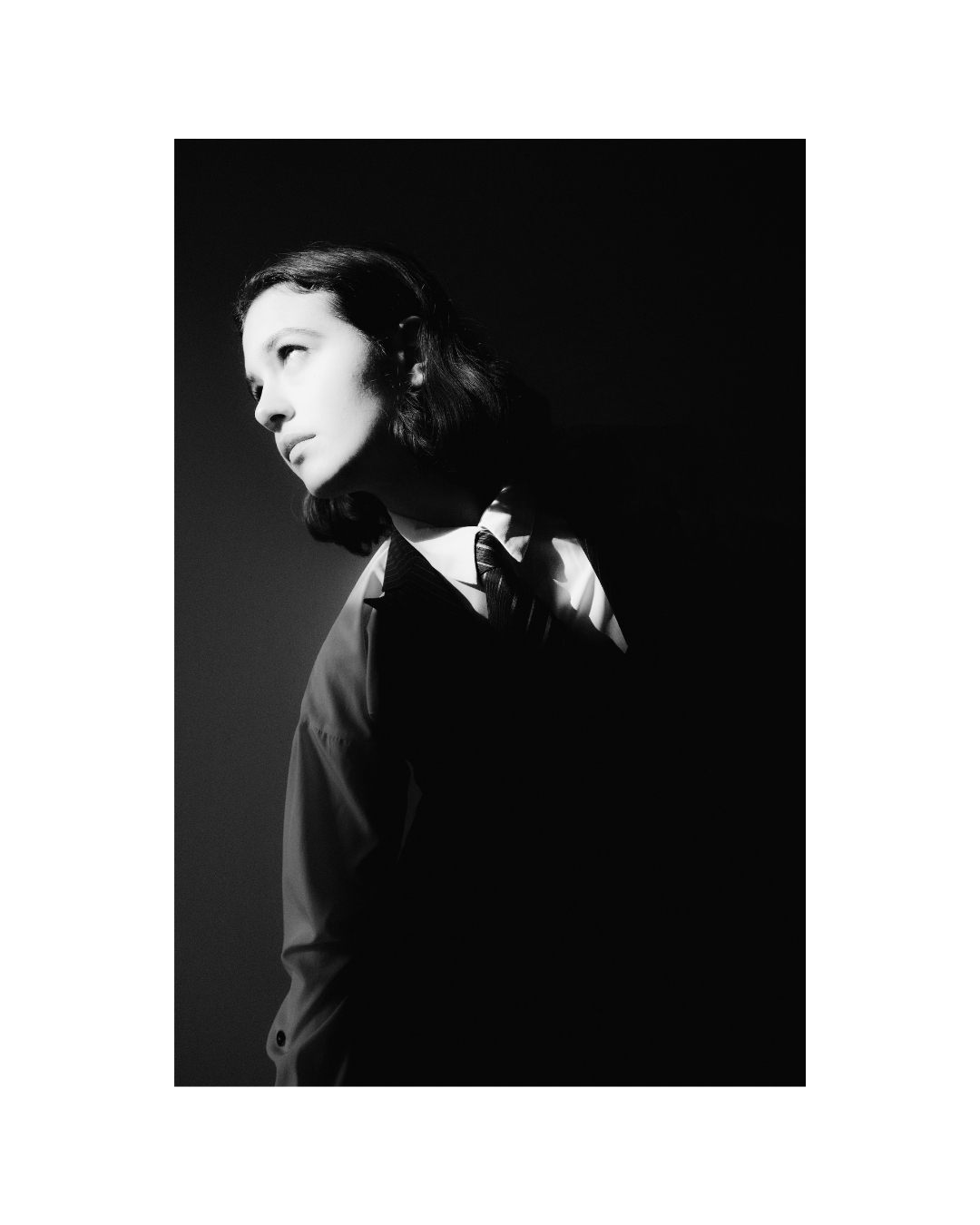 A woman with short dark hair in a vertical monochrome composition by Lilit L Hovhanni.