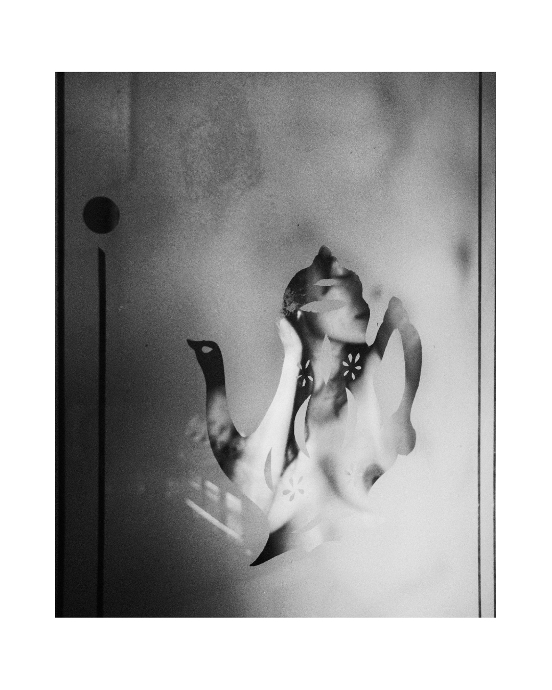A woman's face seen through patterned glass in black and white, by Lilit L Hovhanni.