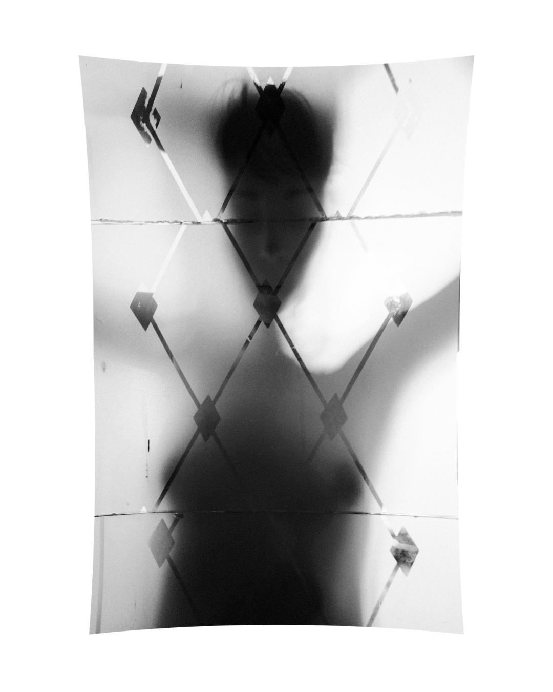 A figure seen through translucent patterns in black and white, by Lilit L Hovhanni.