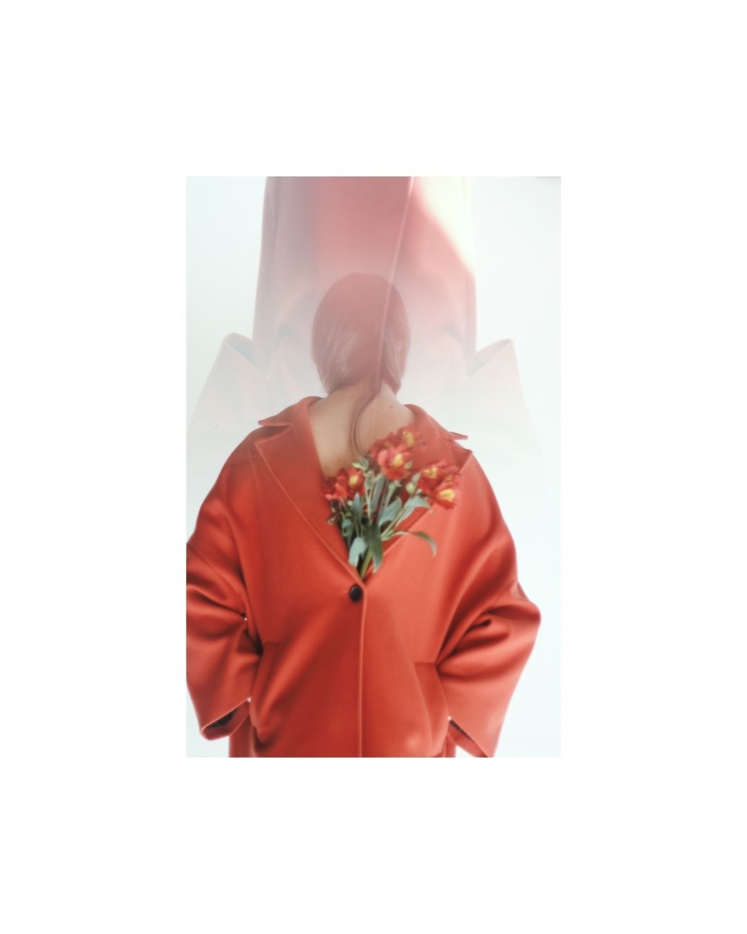 Colour view of a figure in a red coat, with pale walls and folds of fabric.