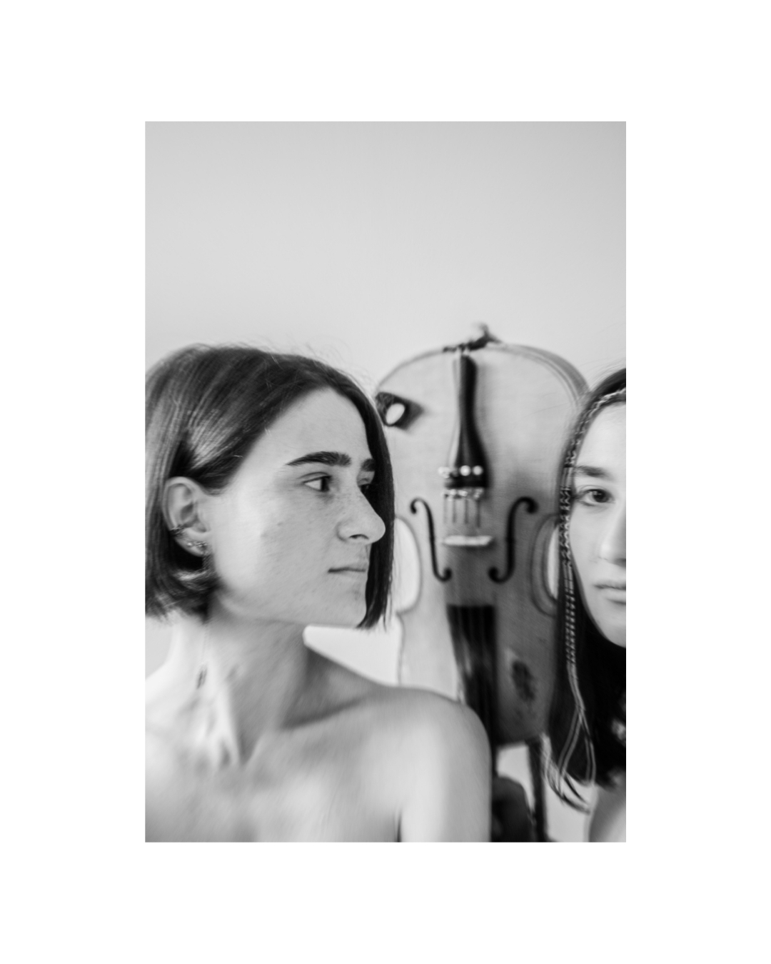 Closely framed women against a pale background in black and white, by Lilit L Hovhanni.