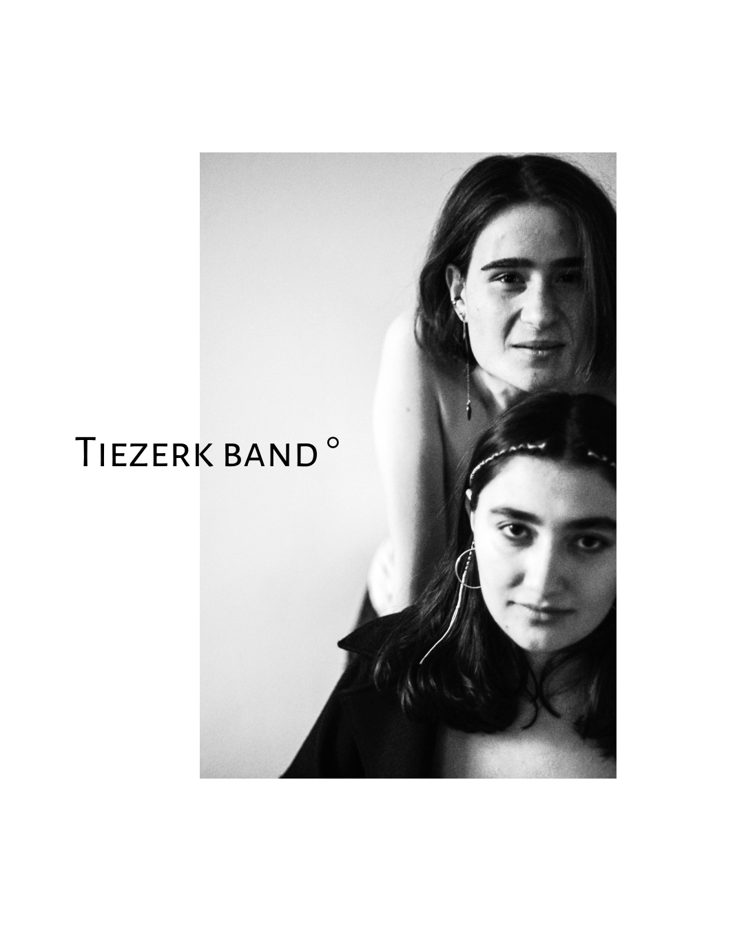 Black-and-white view of women's faces and shoulders against a plain, light backdrop.