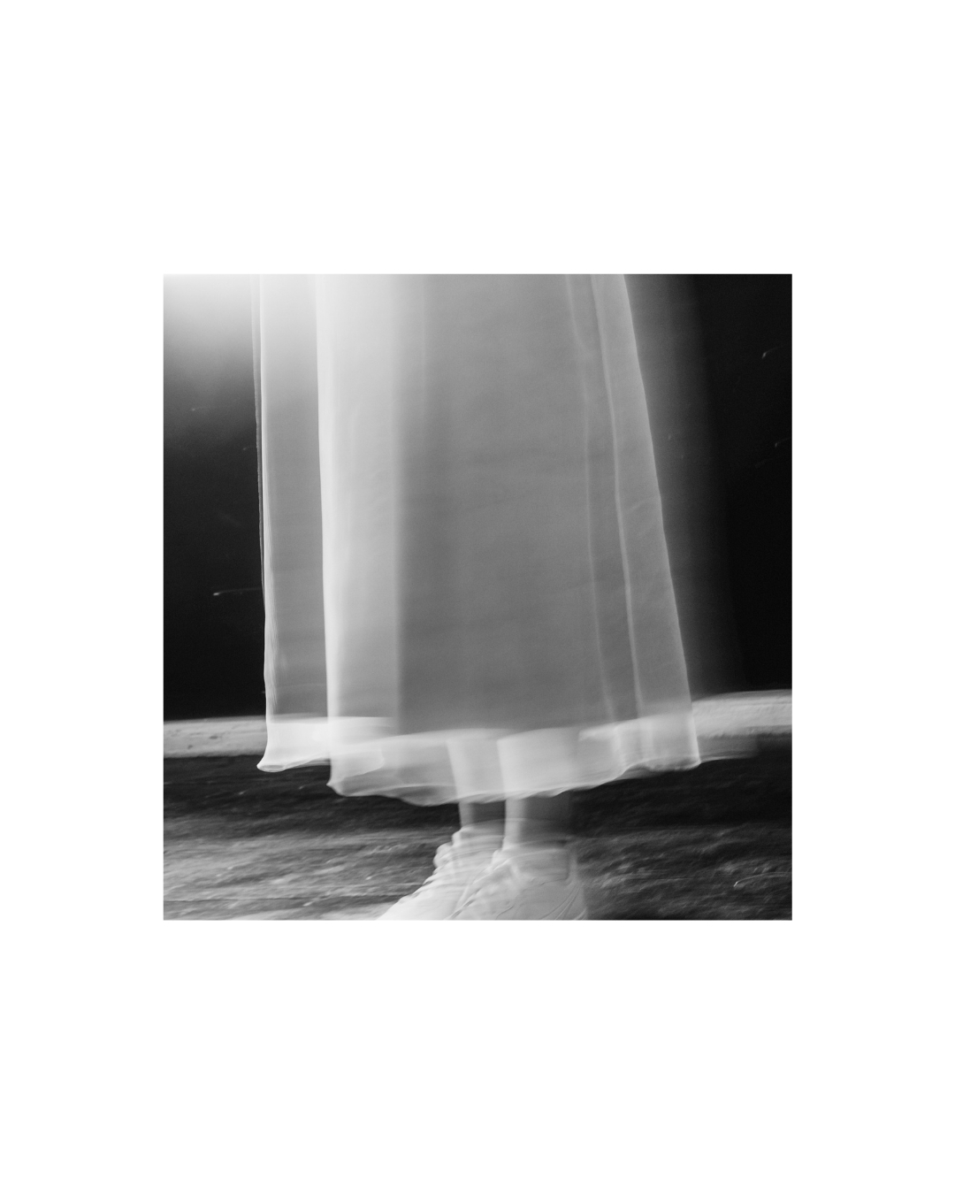 A light dress against a dark wall in a monochrome interior study by Lilit L Hovhanni.