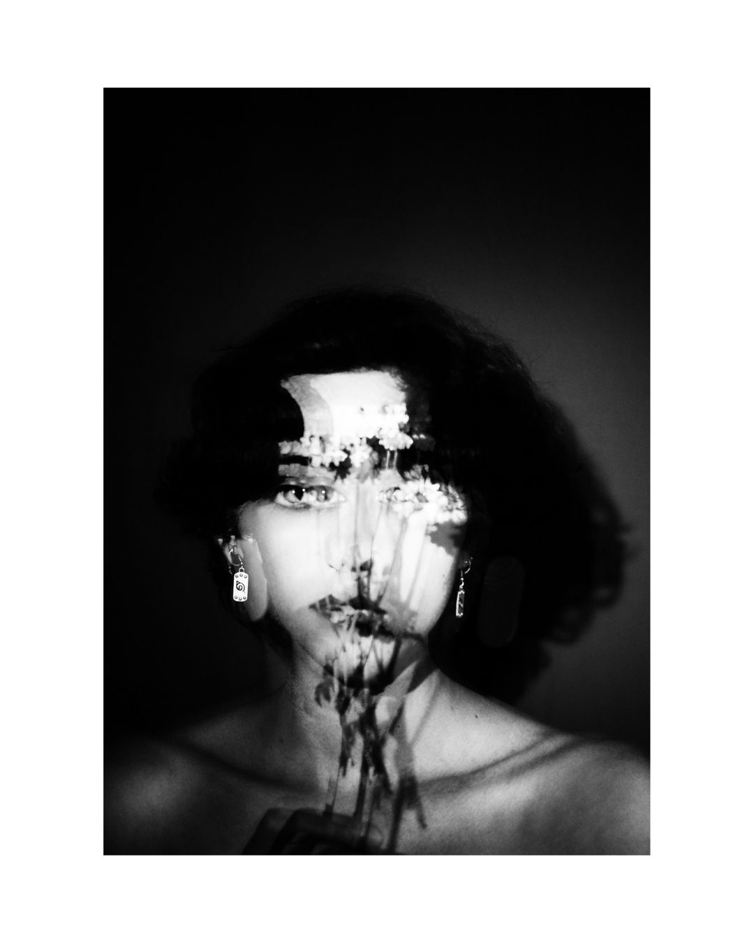 A centrally placed person, shown with only part of the body visible, in a vertically framed composition.