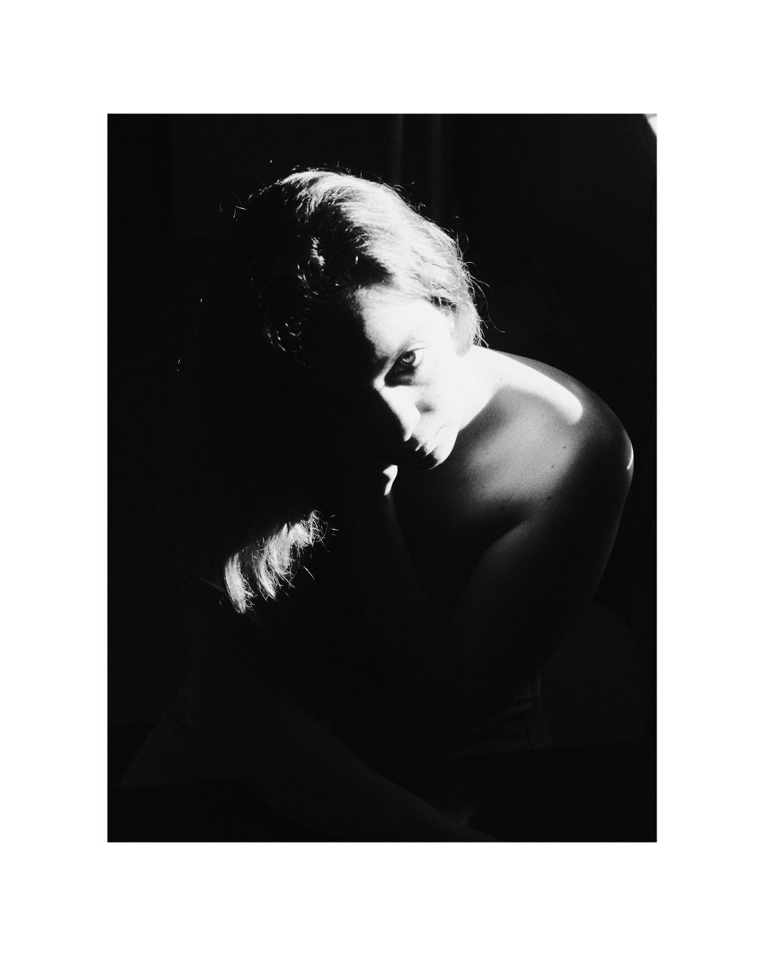 Cropped view of a person in a vertical frame with a white border, by Lilit L Hovhanni.