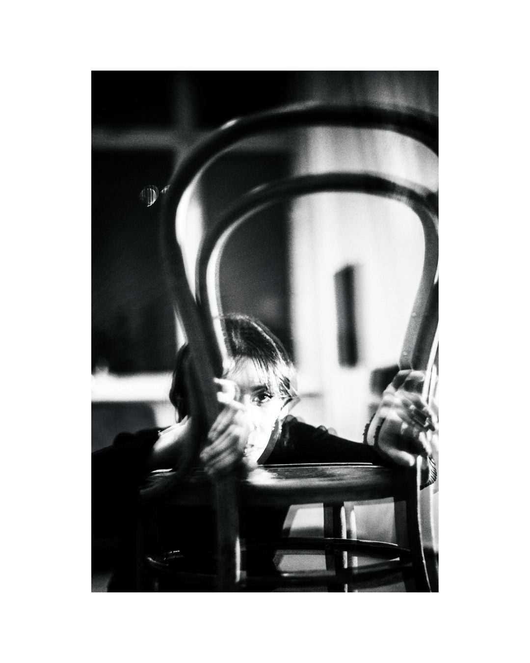 A centrally placed person, shown with only part of the body visible, in a vertically framed composition.