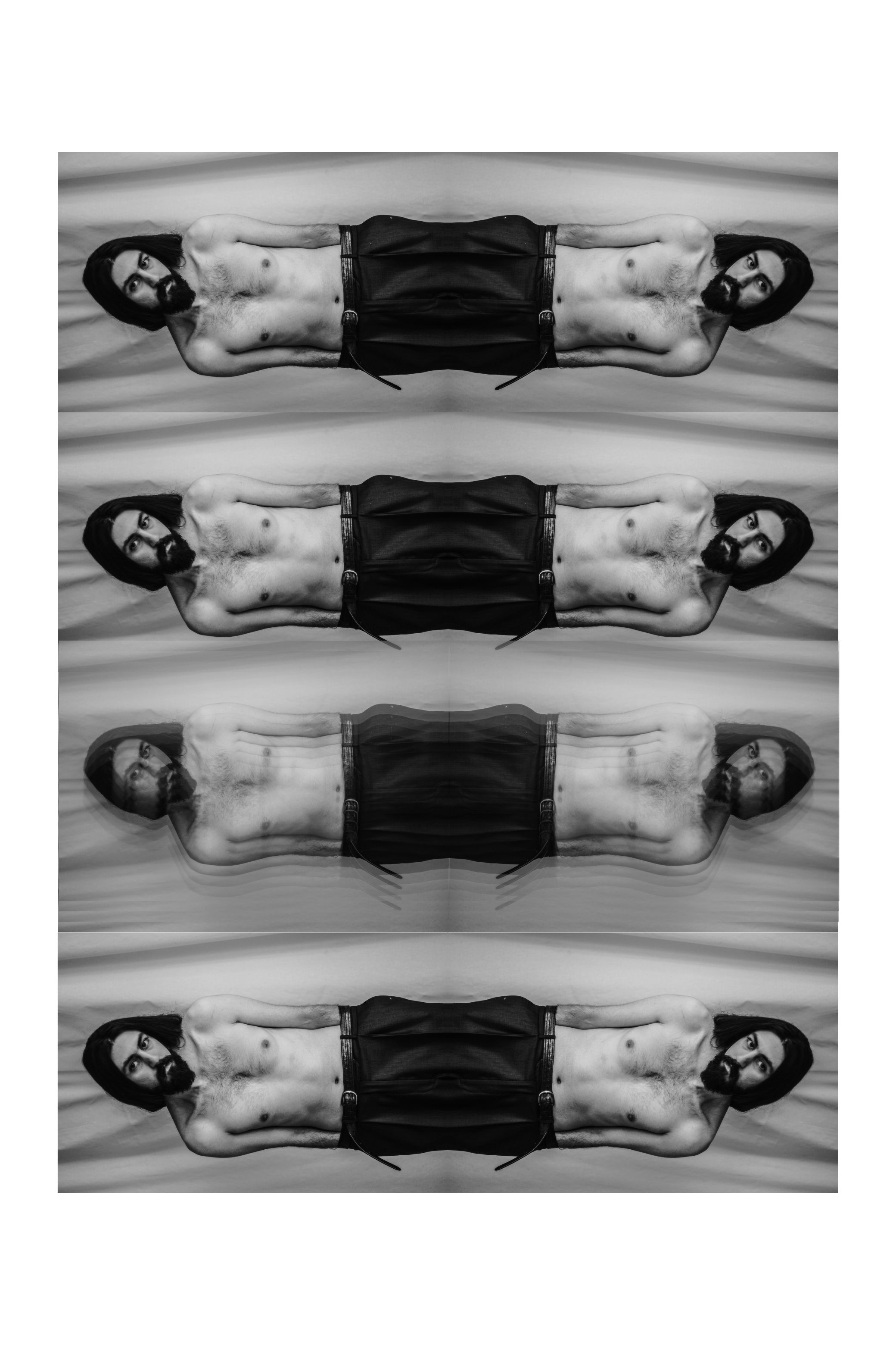 Strips of the same photograph stacked into one tall image, in black and white.