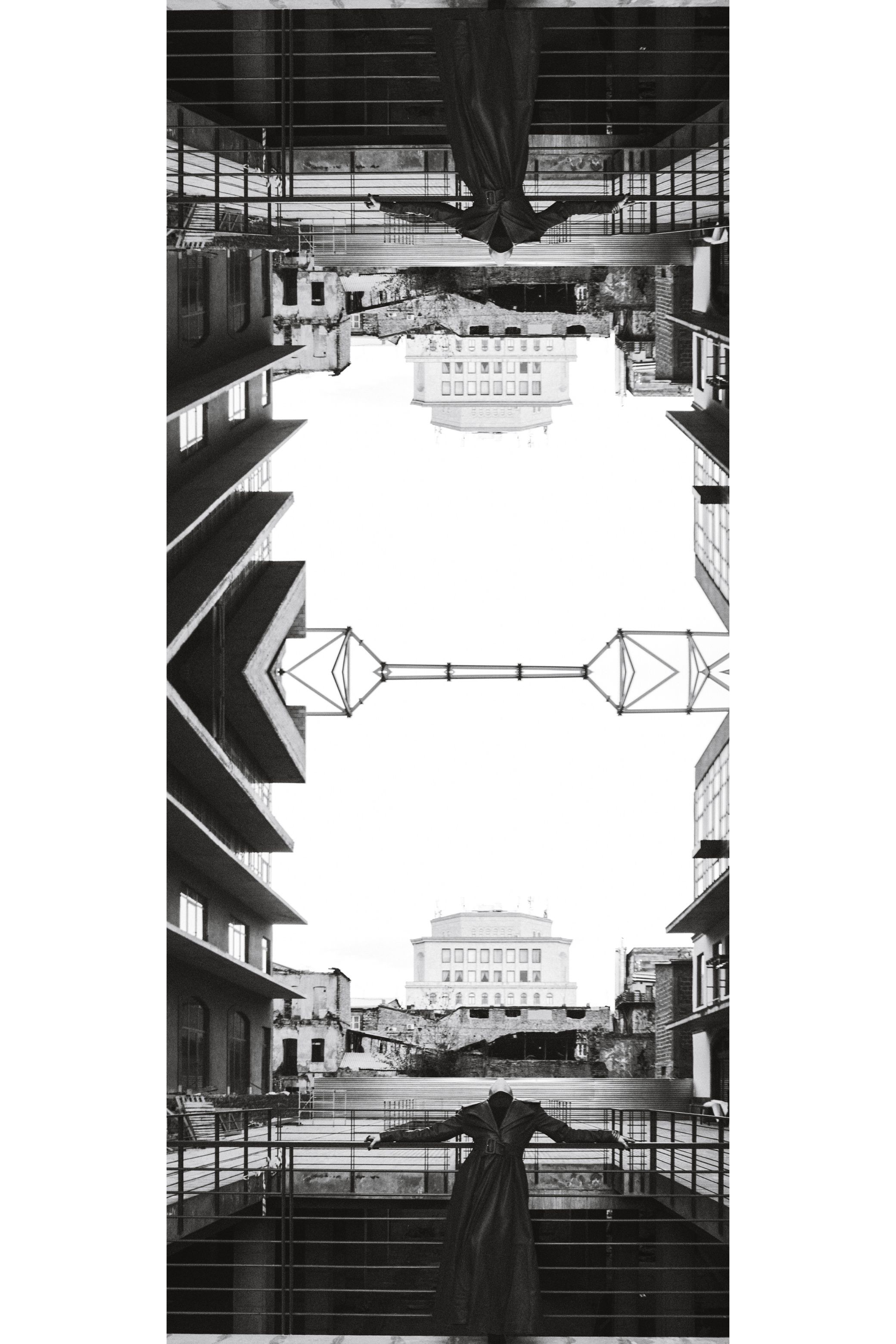 Strips of the same photograph stacked into one tall image, in black and white.
