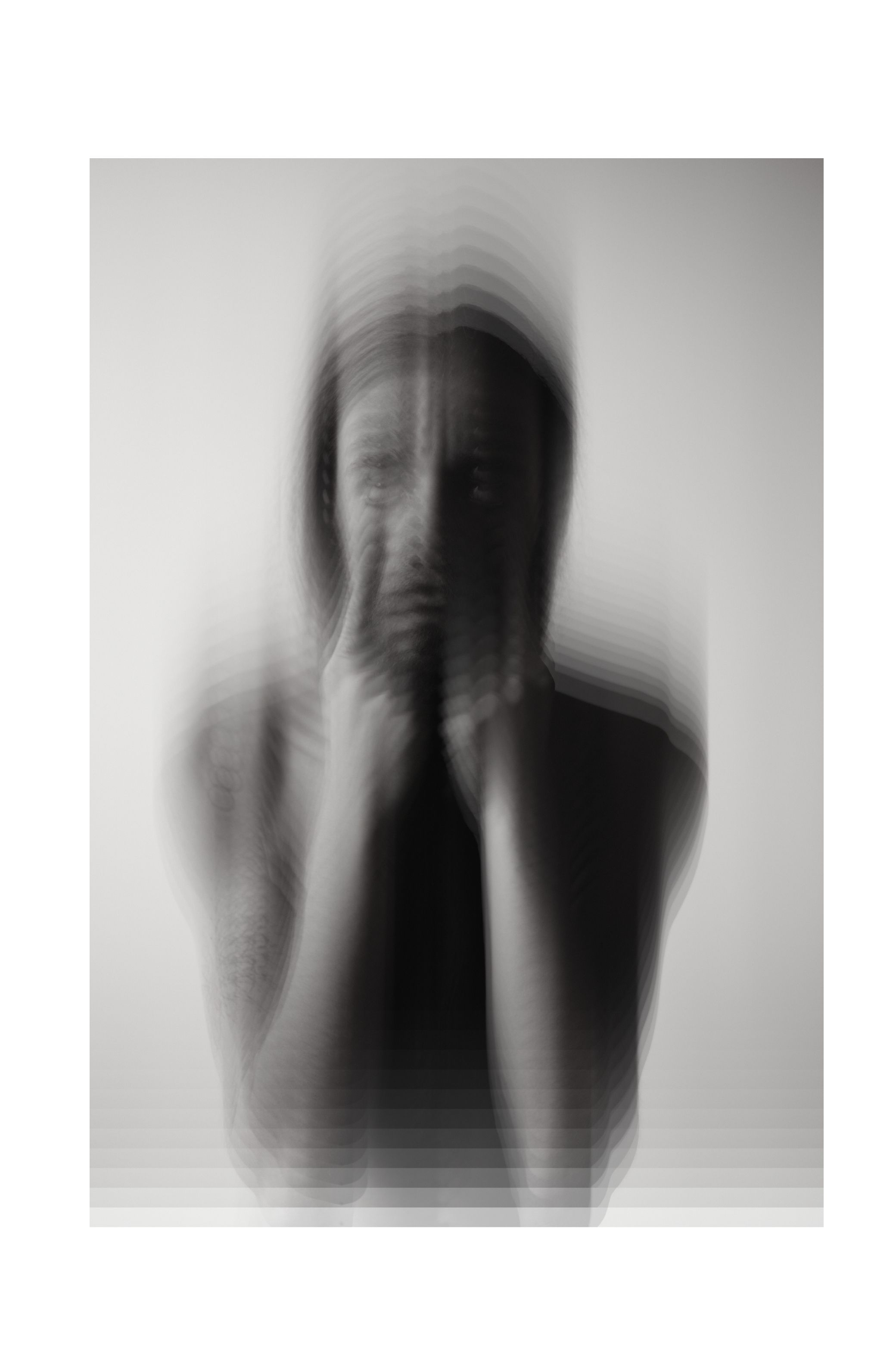 One face or gesture copied over and over into a single frame, in black and white.